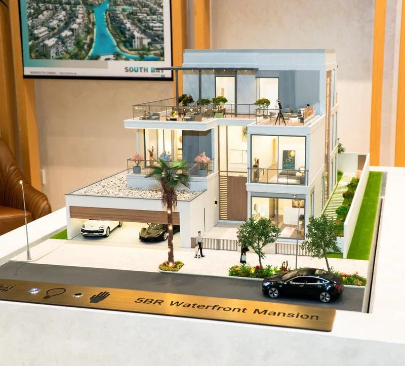 A professional looking at an architectural model with a critical eye